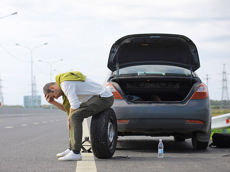 A man sitting on a tire in tension