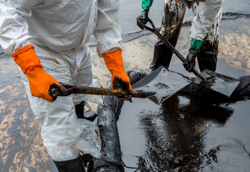 Hawkins Towing workers cleaning and removing oil in Greenville, SC
