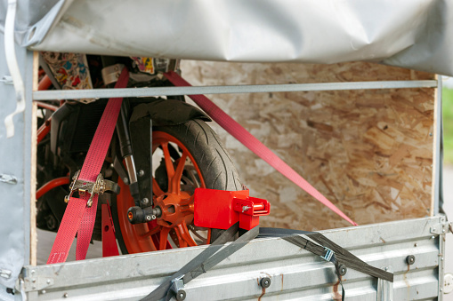 A Motorcycle Strapped in a Trailer