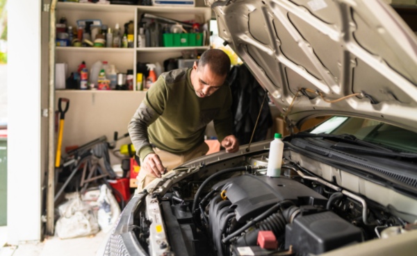 A mechanic is fixing the engine of the car in Greenville, Anderson, & Spartanburg, SC
